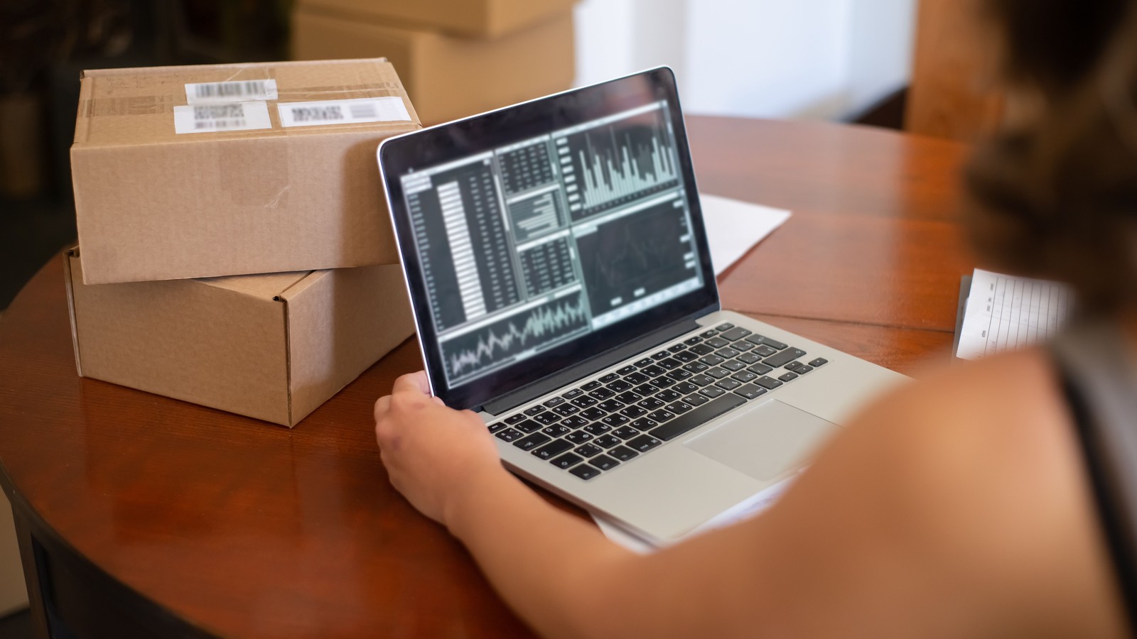 Professional reviewing charts on a laptop