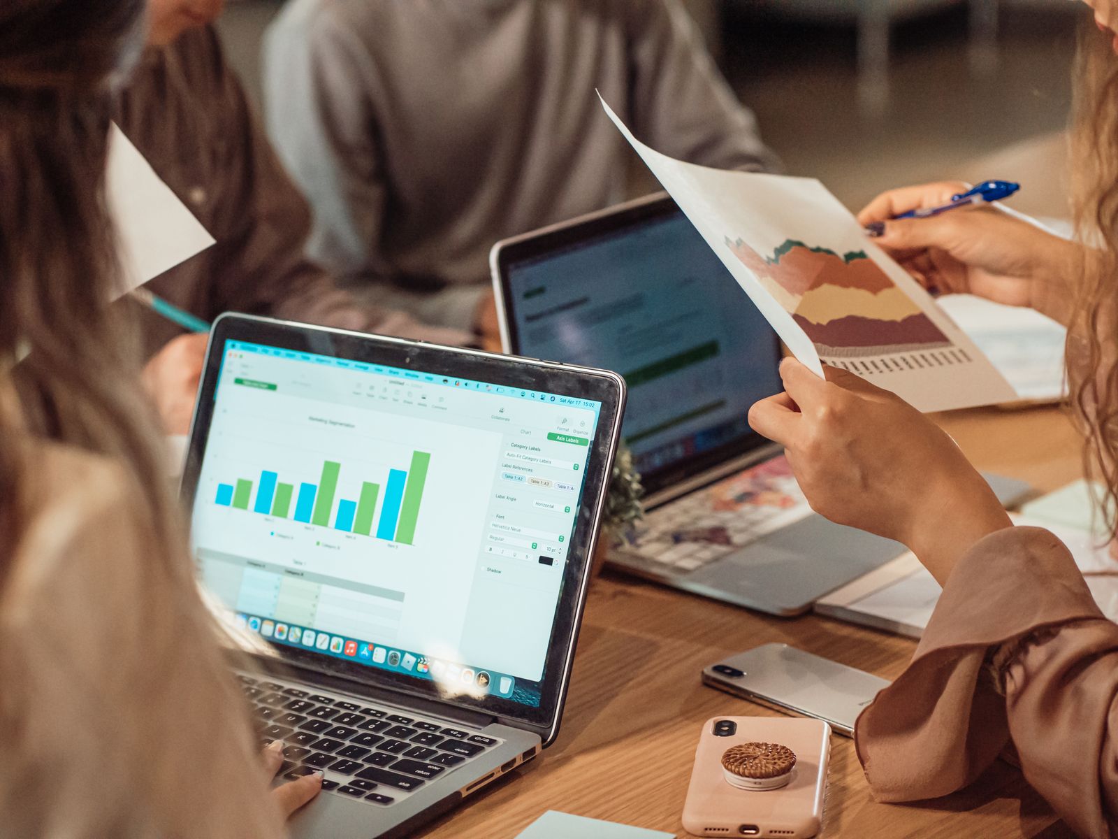 Professionals comparing charts and information