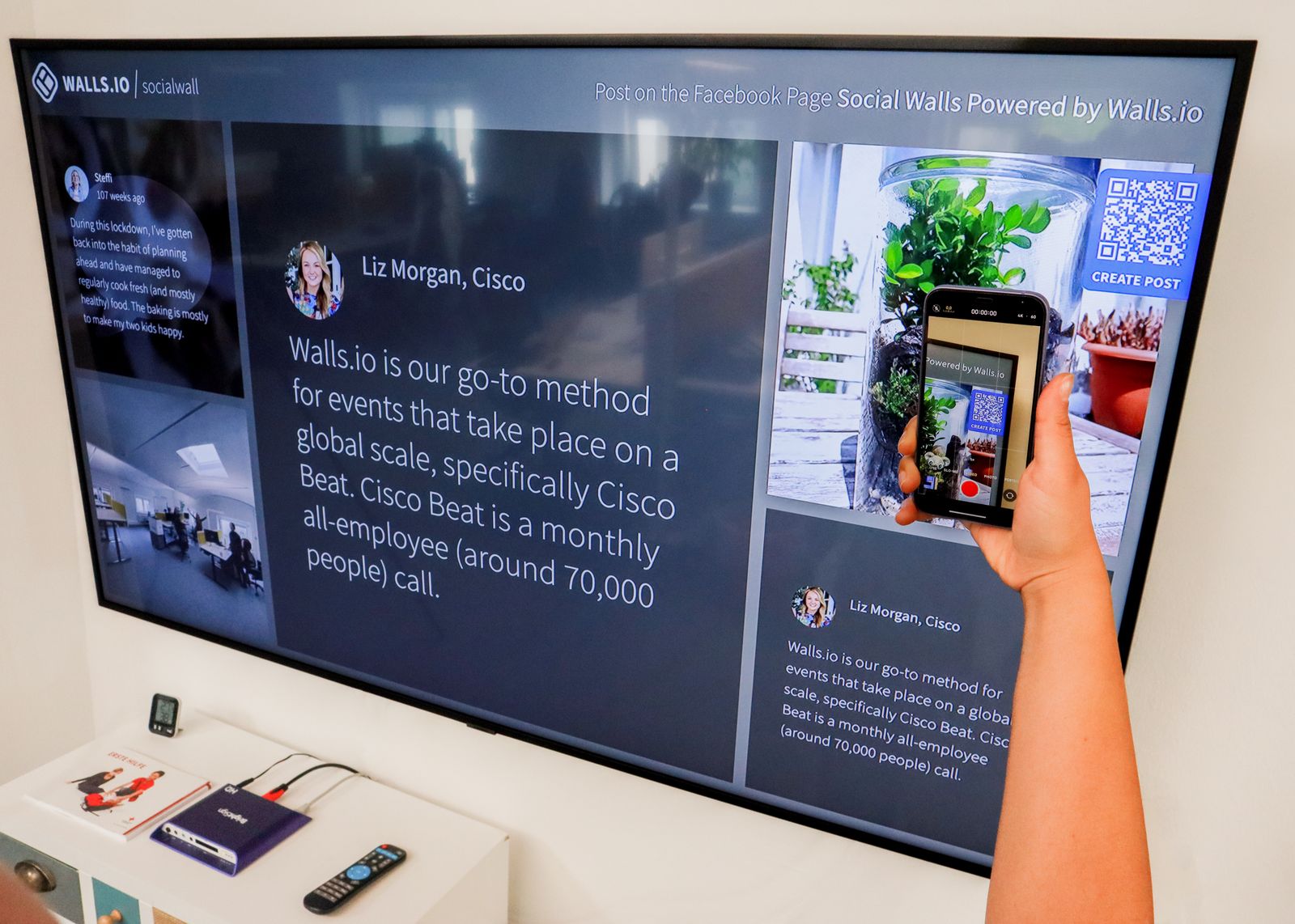 Person inspecting a QR code on a screen with a smartphone