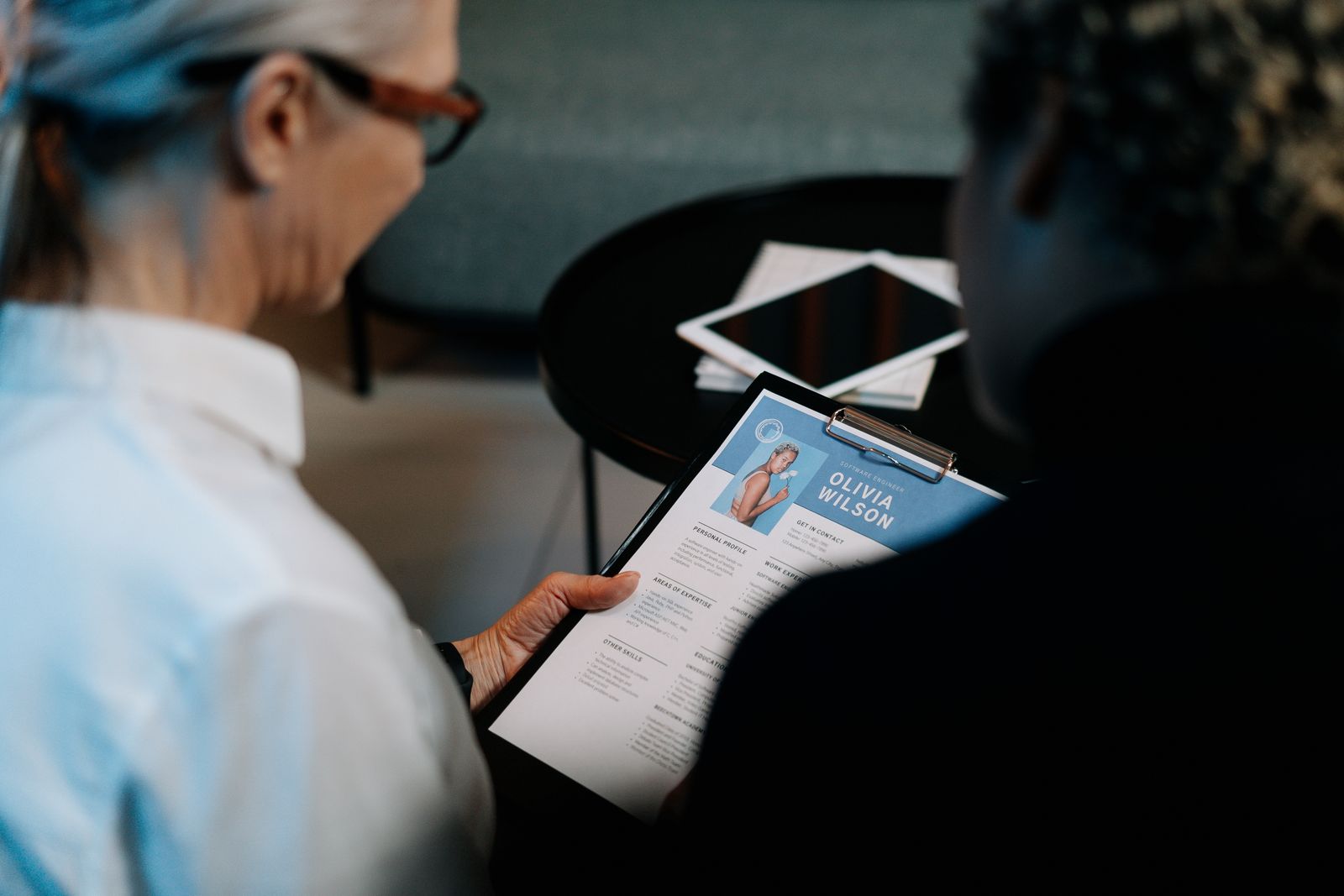 Recruiter reviewing a resume during a conversation
