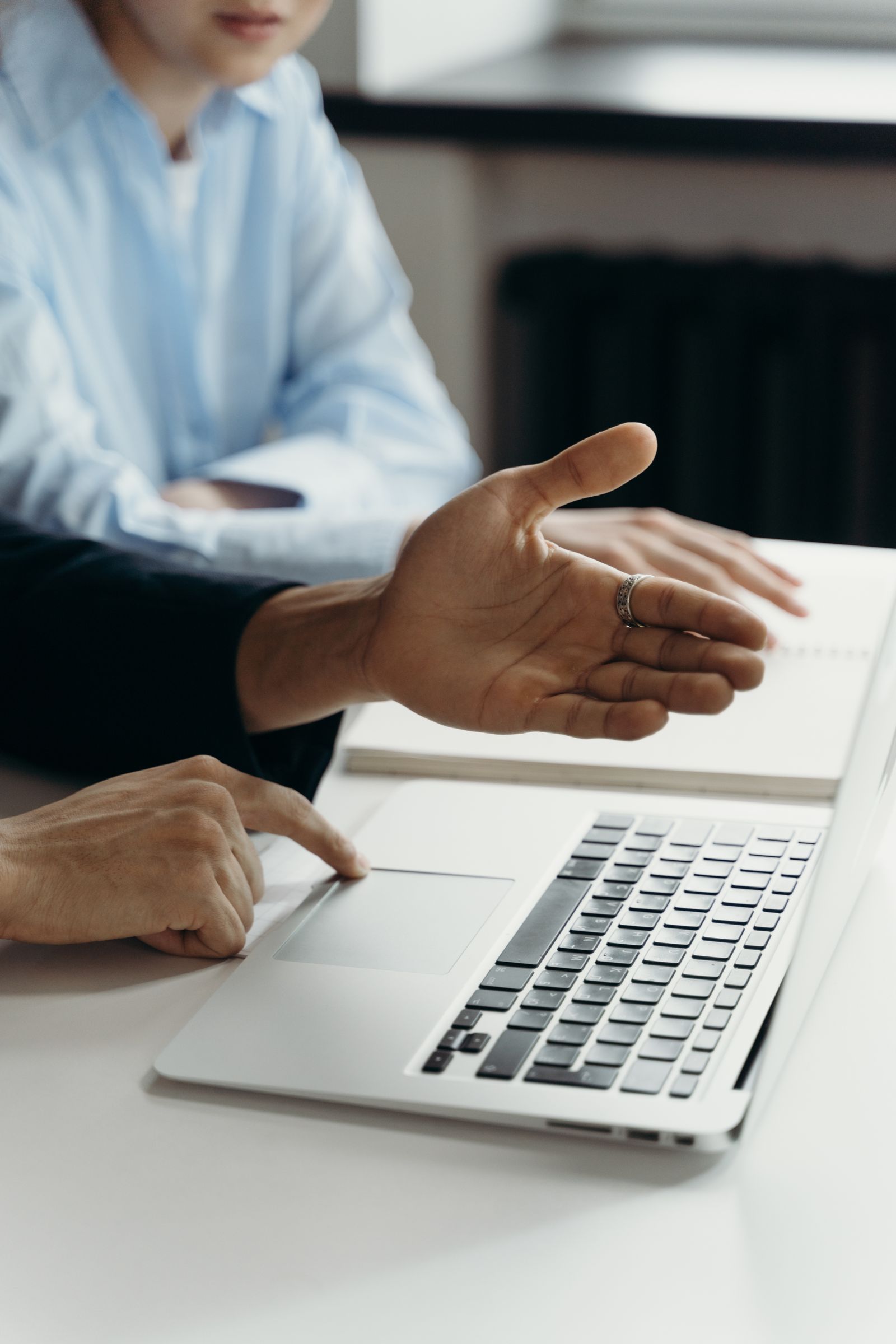 Professionals discussing work at a laptop