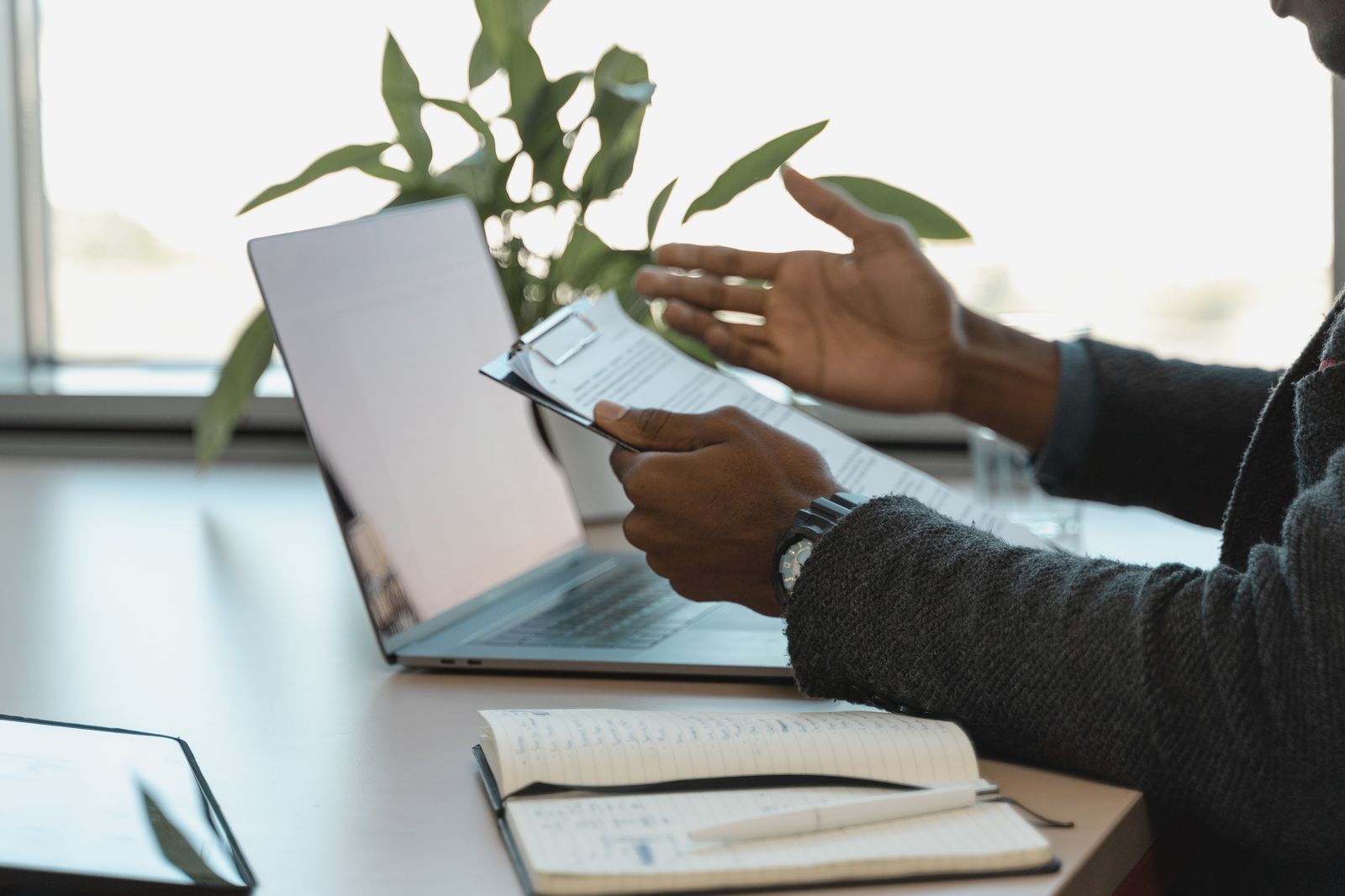 Professional reviewing paper documents at a workspace