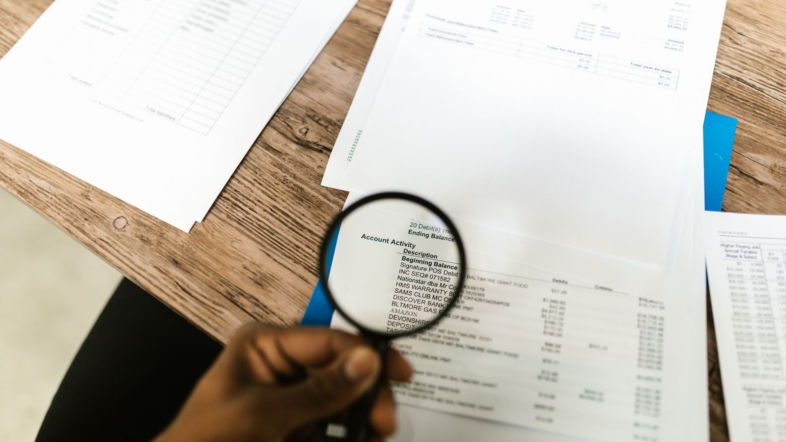 Reviewer inspecting financial evidence for a due diligence data room